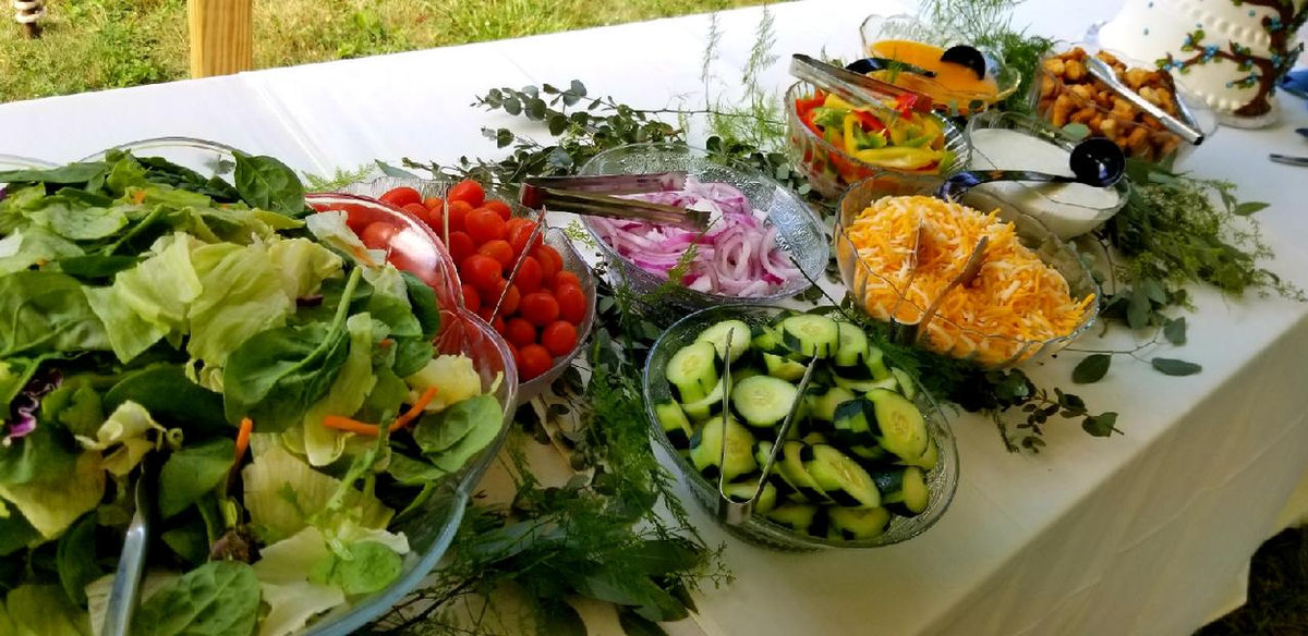 Outdoor tent event setup by Enck's Plus Catering with elegant table arrangements