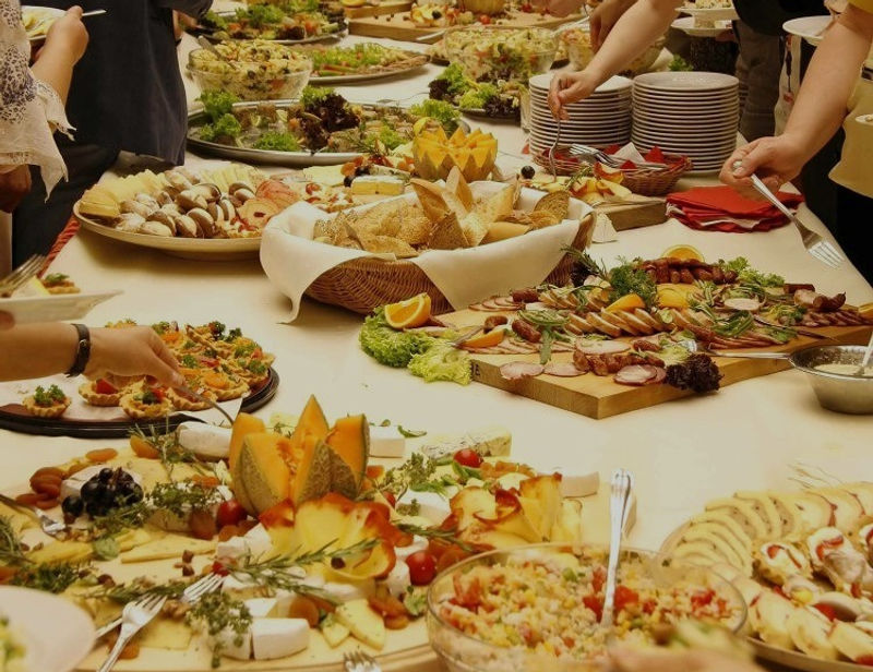 Elegant wedding reception food spread with artfully arranged entrees and garnishes